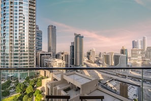 A high-rise building with a view of a cityscape, including modern skyscrapers and a river. - Lux BnB Boulevard Point Tower I Downtown Views (Dubai)