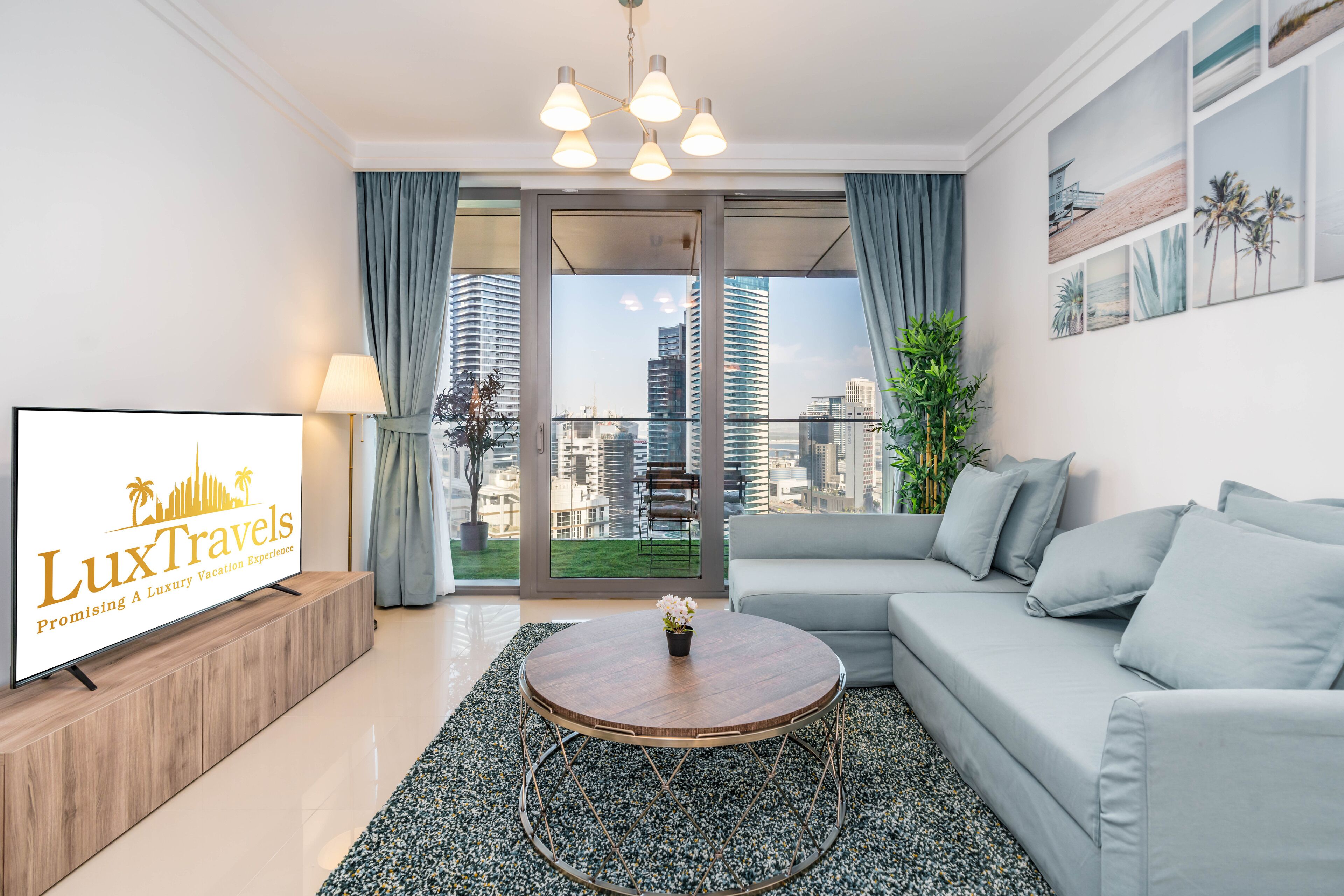 A modern living room with a sofa, a coffee table, and a TV displaying 'LuxTravels'.