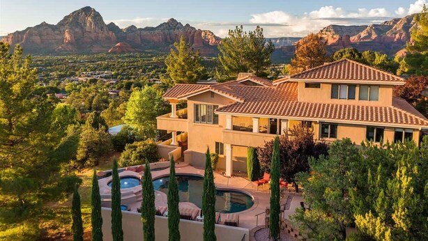 A two-story house with a swimming pool, surrounded by trees and mountains. - Hill-top Haven w/ Heated pool & spa, expansive views and more! (Sedona)