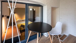 A compact room with a bed, a small table, and a white chair. - A little bit of greenery and calm in the middle of the city! The 3rd. (La Roche-sur-Yon)