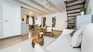 A modern living room with a sofa, a coffee table, and a staircase. - Yellow House Rovinj (Rovinj)