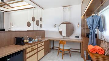 A modern kitchen with a built-in coffee maker, a sink, and a wooden dining table.