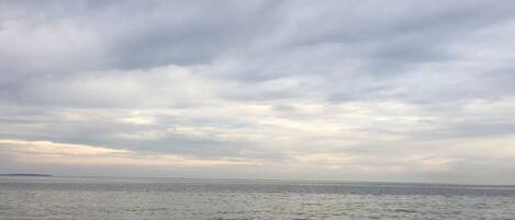 A calm sea with a cloudy sky.