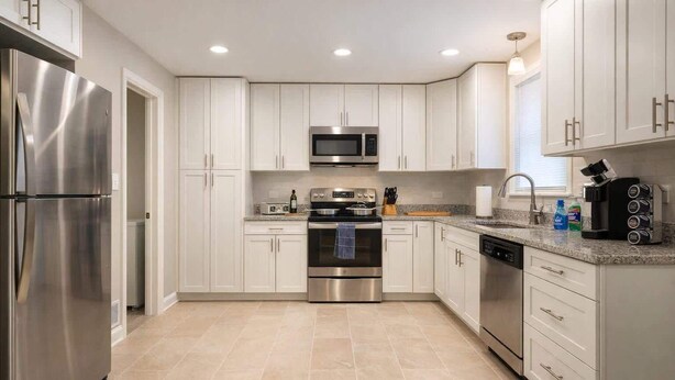 A modern kitchen with stainless steel appliances, white cabinetry, and a granite countertop. - *The Comfy King Ranch*King Bed Suite*Fast Wi-Fi (Worth)