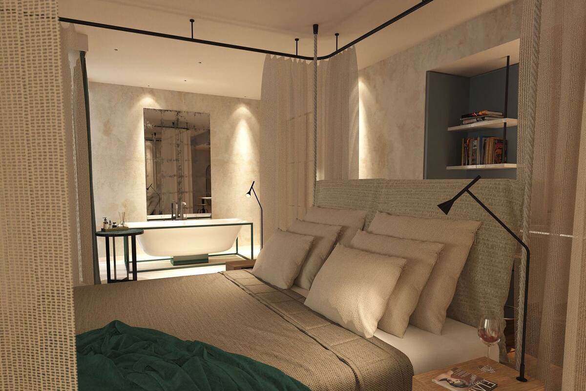 A modern bedroom with a large bed, bedside tables, a mirror, and a bookshelf.