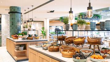 A buffet area with various food items and wooden serving bowls.
