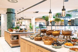 A buffet area with various food items and wooden serving bowls.