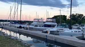 Un puerto deportivo con varias embarcaciones amarradas a lo largo de un muelle de madera.