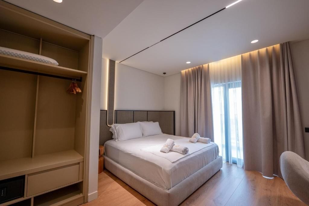 Une chambre d’hôtel moderne dotée d’un grand lit, d’une armoire et d’un coin salon.
