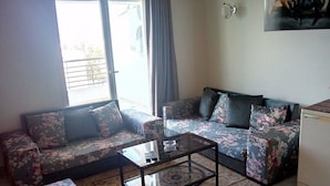 A living room with two sofas, a coffee table, and a small cabinet. - Superb apartment in residence monaco, sousse (sousse)