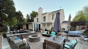 A patio area with a stone fire pit, outdoor furniture, and a hammock. - 2,300 Sqft 2 Story Home With 3 Bedrooms 21/2 Bathrooms in Apex North Carolina (Apex)