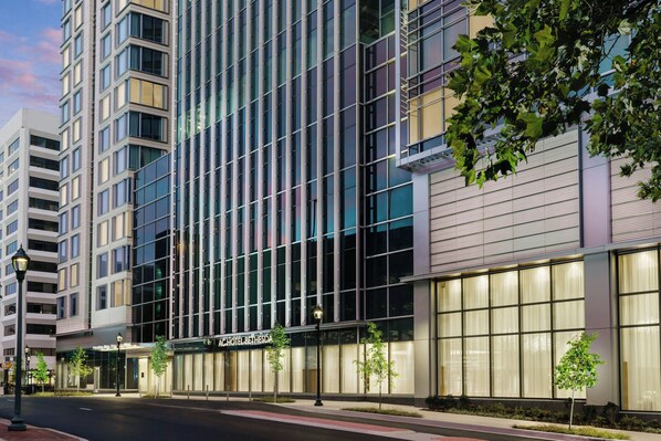 Hotel Bethesda features a sleek, modern design with a prominent entrance and lush greenery.