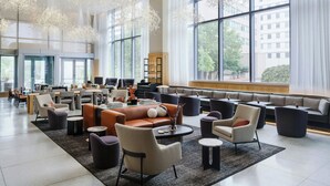 A spacious lobby with modern seating, large windows, and contemporary lighting fixtures. - AC Hotel by Marriott Bethesda Downtown (Bethesda)