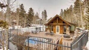 A lodge with a wooden exterior, a fenced patio area, and a pool. - On Keystone Lake/Shared Hot Tub/Quick Shuttle Ride to the Lifts (Keystone)