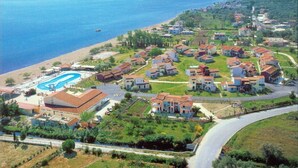 An aerial view of a coastal resort with villas, a swimming pool, and a beach. - Apartment with excellent sea view beside the beach (Lefkimmi)