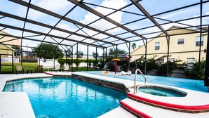 Ein Schwimmbad mit Glasverkleidung, einem Whirlpool und einem Wasserspiel.