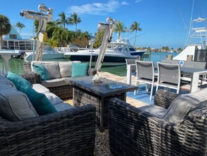 Relax by the marina with comfortable wicker furniture and a view of the water.