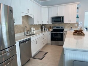 Enjoy cooking in this well-equipped kitchen with a microwave, double oven, and dishwasher.