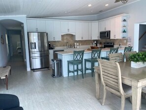 Enjoy meals in the kitchen with stainless steel appliances and a central island, or dine at the wooden table with matching chairs.