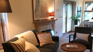 Un soggiorno moderno con un divano, un tavolino da caffè e un camino.