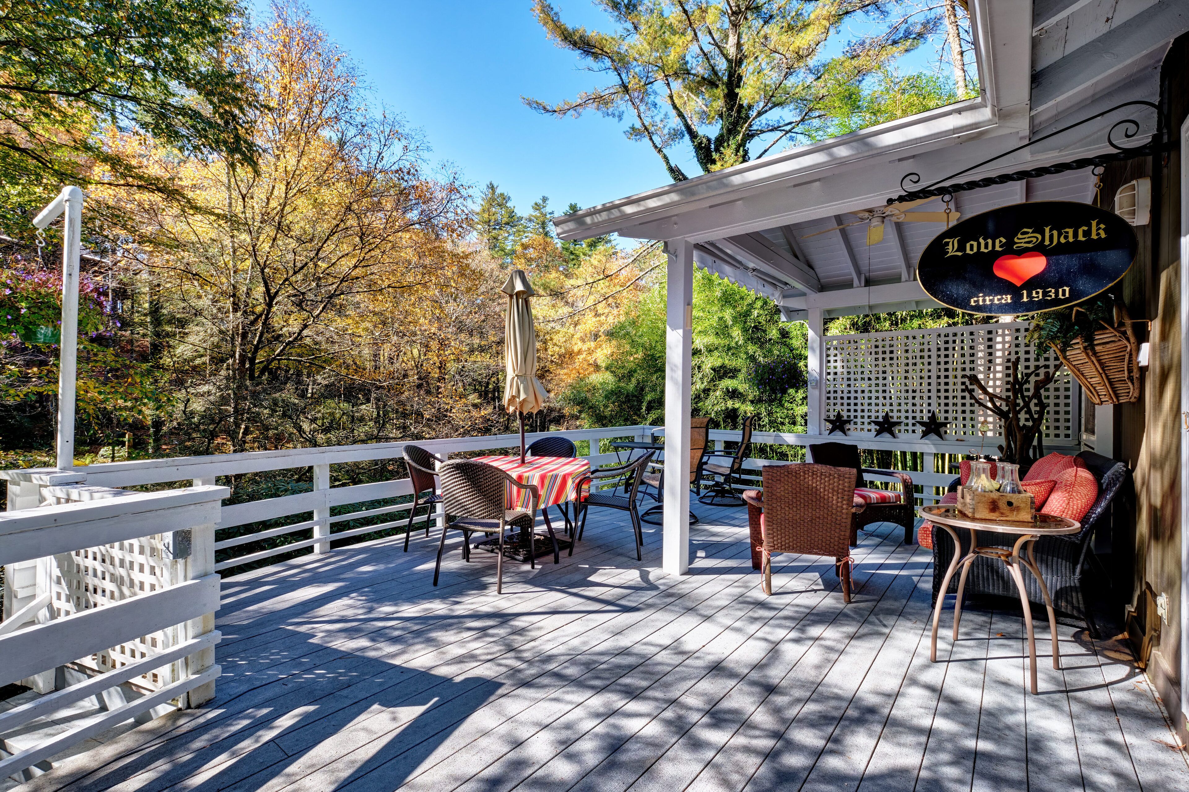 A covered outdoor deck with a sign reading "Love Shack circa 1930".