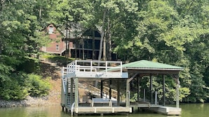 A wooden dock with a covered seating area and a staircase leading to a platform. - "A Place To Land" on WATTS BAR LAKE with a PRIVATE BOAT DOCK! (Spring City)