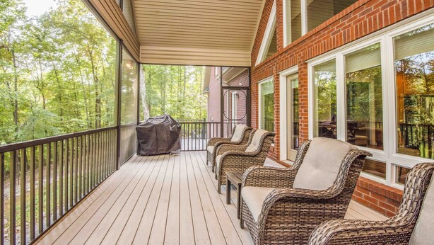 A covered outdoor deck with wicker furniture and a grill. - "A Place To Land" on WATTS BAR LAKE with a PRIVATE BOAT DOCK! (Spring City)