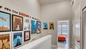 A hallway with framed artwork on the walls and a bed in the background. - Windsor Hills Resort/3Bed/POOL/Near Disney (Kissimmee)