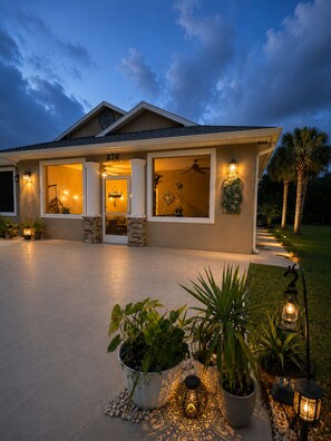 A modern house with a number 270, a covered entryway, and outdoor lighting.