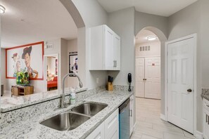 Clean, bright, and ready for your culinary adventures—this kitchen is the heart of the home - Windsor Hills Toy Storey 3BR Condo I Water Park (Kissimmee)