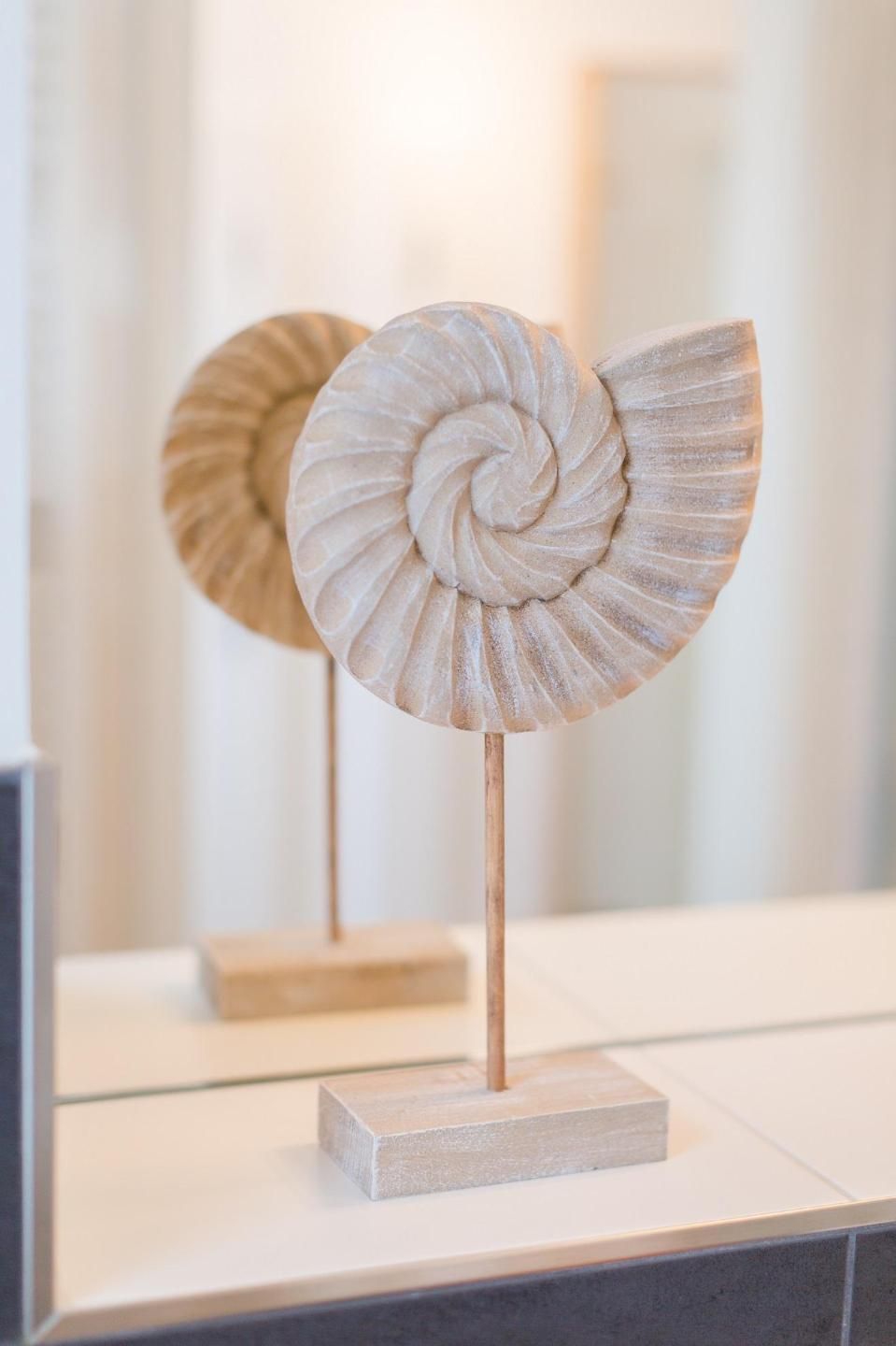 A sculpture with a spiral design on a pedestal.