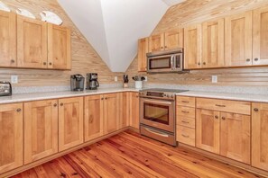 Enjoy cooking in this well-equipped kitchen with a microwave, coffee maker, and stainless steel oven.