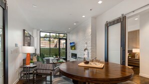 A modern dining area with a round table, cushioned benches, and a fireplace. - Unbeatable Location, Hot Tub, Luxury Amenities & Year-Round Recreation! Park City Parkite 23 (Park City)