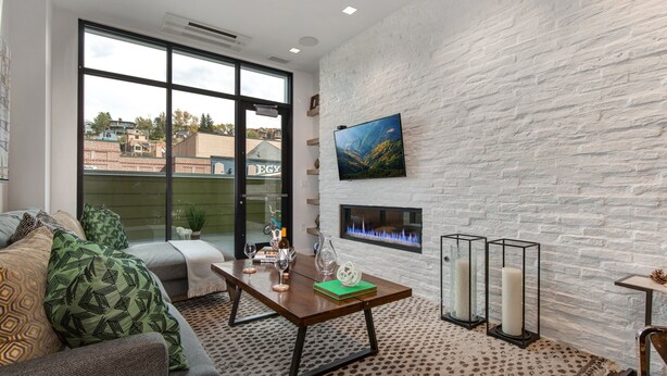 A modern living room with a fireplace, a large window, and a view of the outside. - Unbeatable Location, Hot Tub, Luxury Amenities & Year-Round Recreation! Park City Parkite 23 (Park City)
