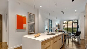 A modern kitchen with a large island, wooden cabinets, and a view to the outdoors. - Unbeatable Location, Hot Tub, Luxury Amenities & Year-Round Recreation! Park City Parkite 23 (Park City)