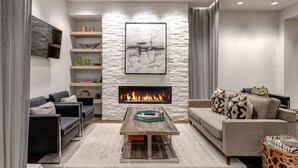 A modern living room with a fireplace, sofas, a coffee table, and a stone accent wall. - Unbeatable Location, Hot Tub, Luxury Amenities & Year-Round Recreation! Park City Parkite 23 (Park City)