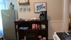 A kitchen with a refrigerator, coffee maker, and various food items on a shelf. - 🤓Clever Studio🍷Free Wine☕️Coffee / Tea Bar - Free Parking! (Dover)