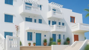 A multi-story white building with blue accents, balconies, and potted plants. - Sleeps5 - Pool - BySea - Garden - Parking - PetOK (Heraklio)