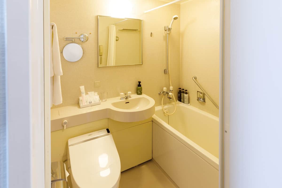grand queen room, non smoking | bathroom | free toiletries, hair dryer, slippers, electronic bidet