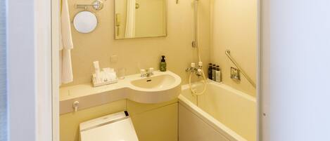 A modern bathroom with a toilet, sink, and bathtub.