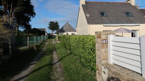 A residential street with a house marked '10' and a pathway leading to it. - Les Dunes by Interhome (Saint Pabu)