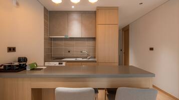 A modern kitchen with a central island, built-in appliances, and a minimalist design.