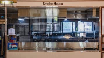 A restaurant named Smoke House with a glass enclosure, industrial kitchen equipment, and a visible temperature control of 248°F.