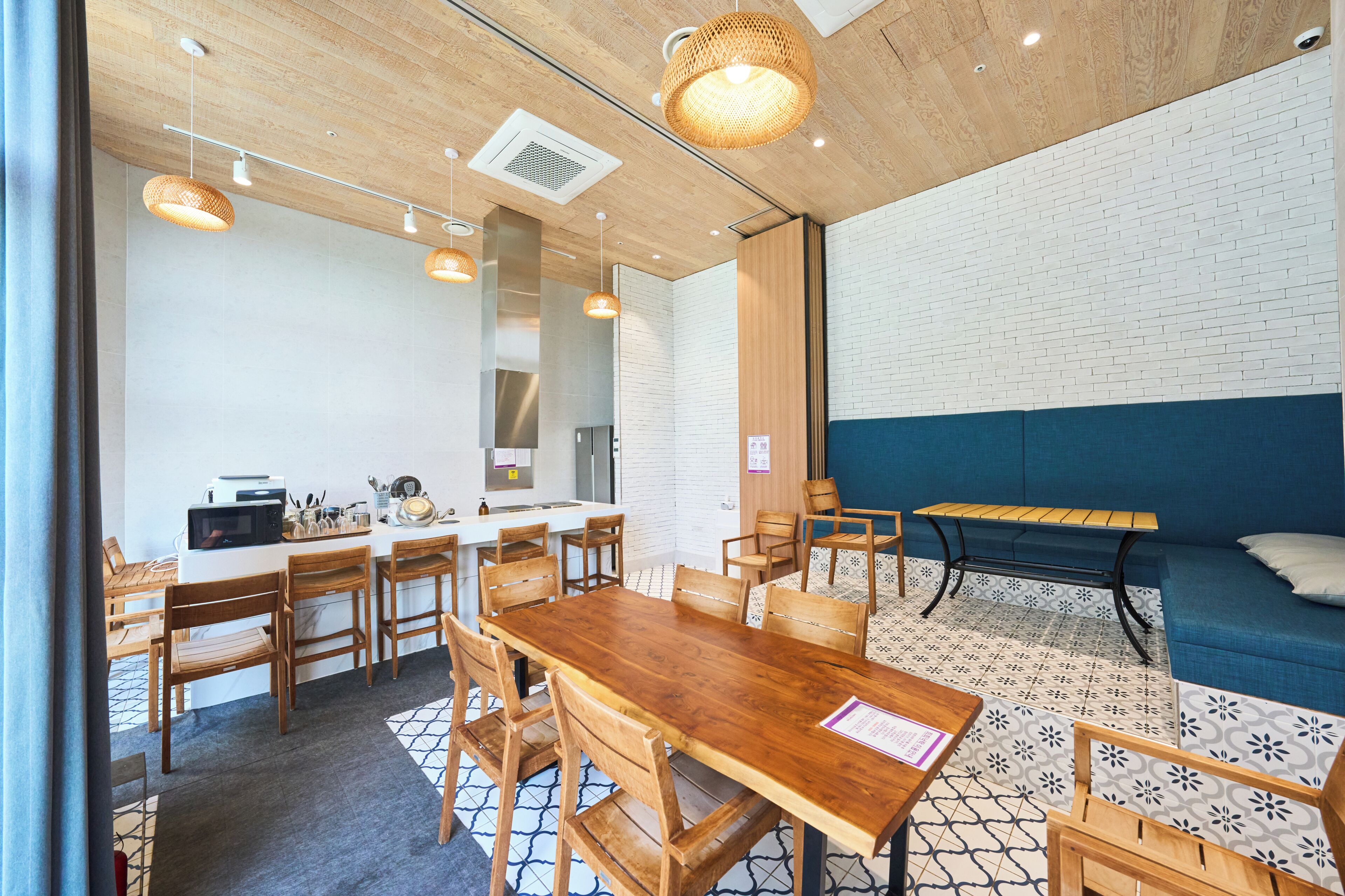 A modern kitchen with a microwave, sink, and stainless steel refrigerator.