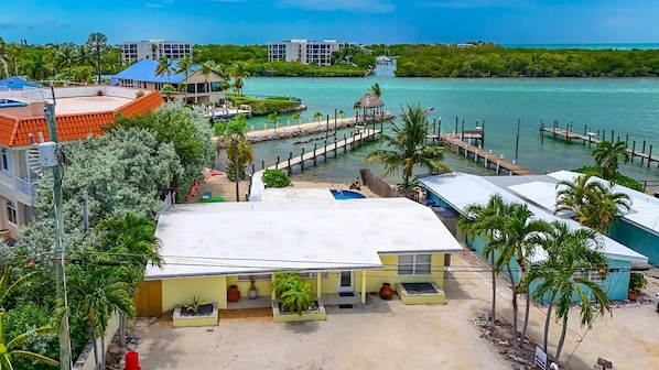A coastal hotel with a large open patio, a dock, and a view of the sea.