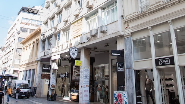 A multi-story building with a ground-floor shop and a visible store named '5 lyfex'.