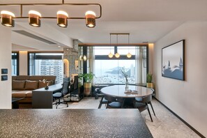 A modern office space with a round table, leather sofa, and potted plants. - The Arca (Hong Kong Island)