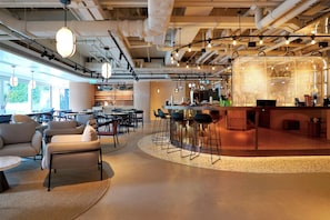 A modern interior with a bar area, seating, and a visible kitchen. - The Arca (Hong Kong Island)