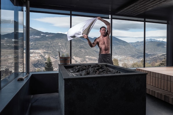 A man in a modern room with a large window overlooking a mountainous landscape. - Santre dolomythic home (Bressanone)