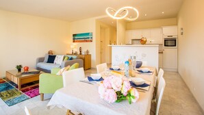 A modern apartment with a dining area, kitchen, and living room. - LE FOCH AP4244 By Riviera Holiday Homes (Niza)
